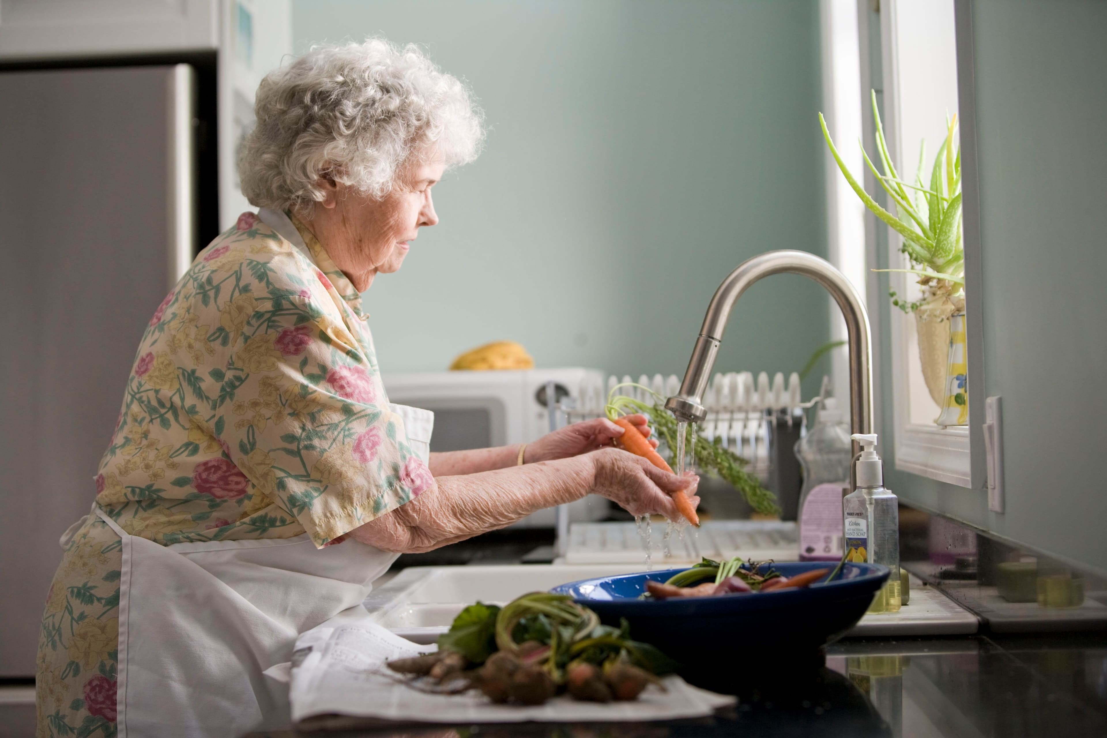 Elderly person maintaining independence in their home kitchen